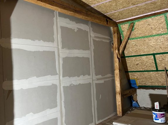Dachgeschossausbau mit Trockenbauplatten und sichtbaren Sparren